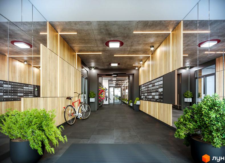 Просторий вестибюль Житлового комплексу HYGGE з дерев'яними стіновими панелями, поштовими скриньками та зоною для зберігання велосипедів.