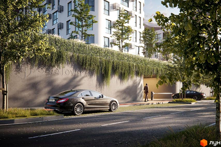 Житловий комплекс Safe Town. Фасад будівлі з великою кількістю вікон, зелені на терасах та прибудинкова територія з автомобілями та пішохідною доріжкою.