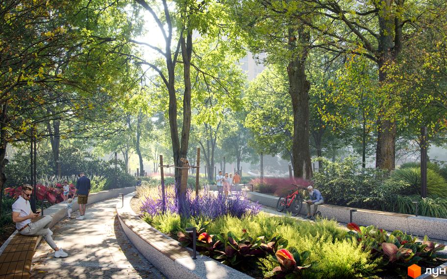 Паркова зона біля ЖК KADORR City з доглянутими зеленими насадженнями, квітами та місцями для відпочинку. Люди насолоджуються прогулянкою серед дерев.