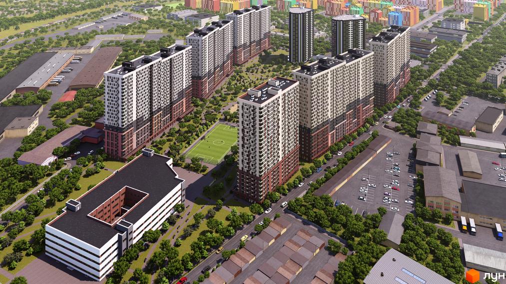 Високі будинки житлового комплексу Star City з фасадами у світлих тонах. На прибудинковій території є зелені насадження, парковка та футбольне поле.