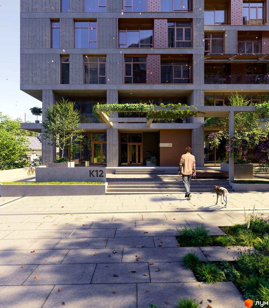 Клубний будинок К12 з фасадом з вертикальних елементів та великими вікнами. На прибудинковій території зелені насадження та бруківка.