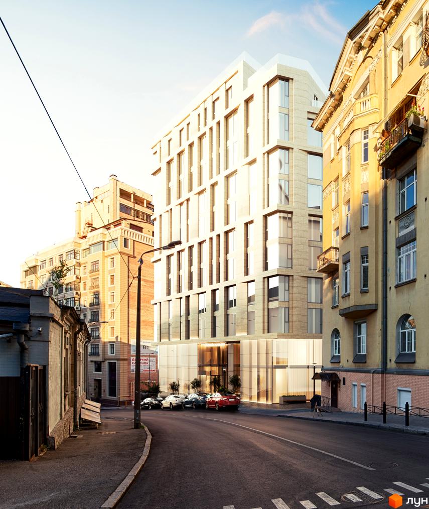 Житловий комплекс Krauss Gallery – багатоповерховий будинок світлого кольору з великими вікнами. На вулиці перед ним припарковані автомобілі, поруч стоять старіші будівлі.