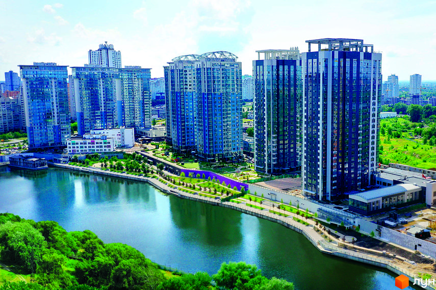 Житловий комплекс RiverStone з висоти пташиного польоту. Сучасні багатоповерхові будинки біля річки з доглянутою прибудинковою територією та зеленими зонами.