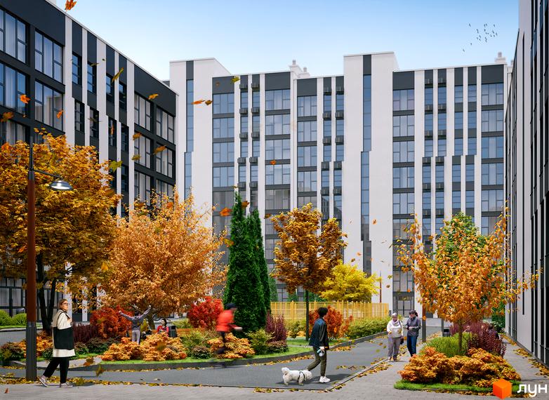 Багатоповерхові будинки Житлового комплексу Сонячний з білими та темними вертикальними фасадами і великими вікнами. Прибудинкова територія з осінніми деревами, кущами та пішохідними доріжками.