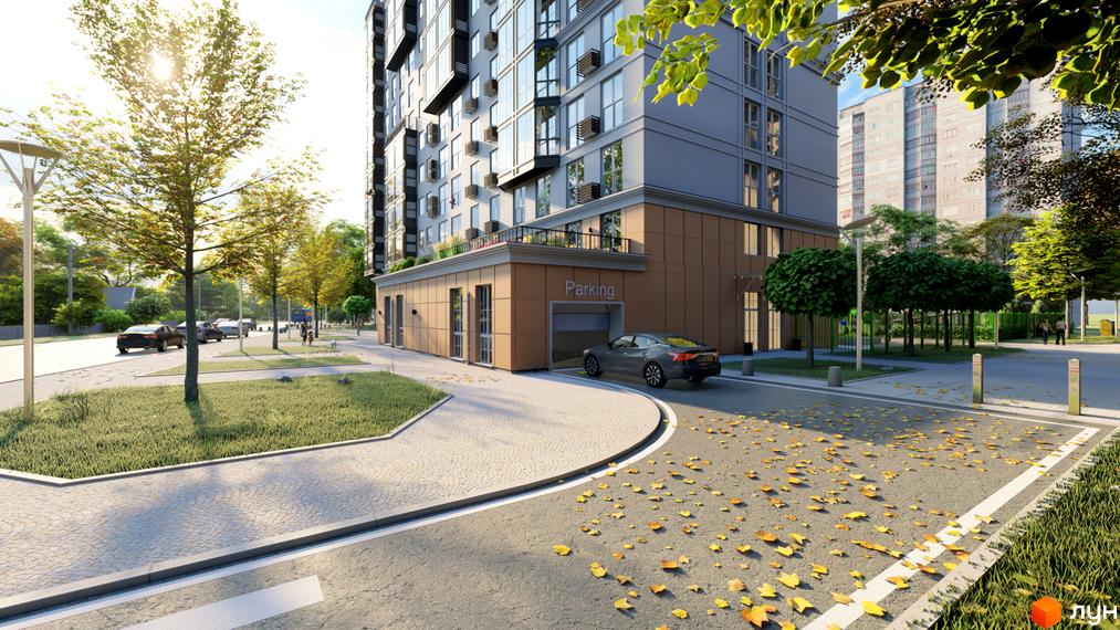 Житловий комплекс Янтарний з паркінгом та доглянутою прибудинковою територією. Навколо будинку зелені насадження та дорога з опалим листям.