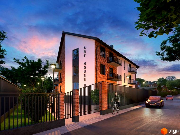 Новобудова Art House з цегляним фасадом та балконами на тлі вечірнього неба. Територія огороджена парканом, поруч дорога з автомобілями та пішохід на велосипеді.