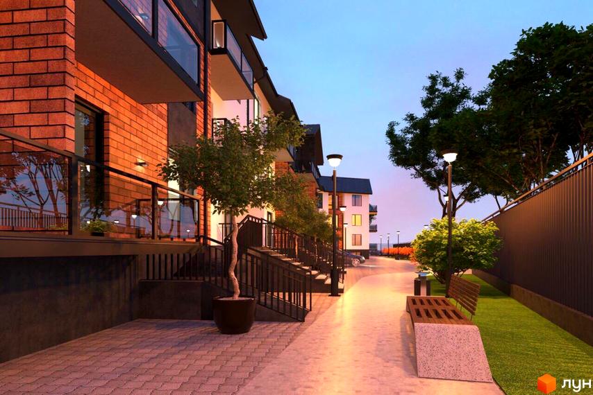 Новобудова Art House з цегляними фасадами та балконами. Територія має вимощені доріжки, дерева та вуличні ліхтарі.