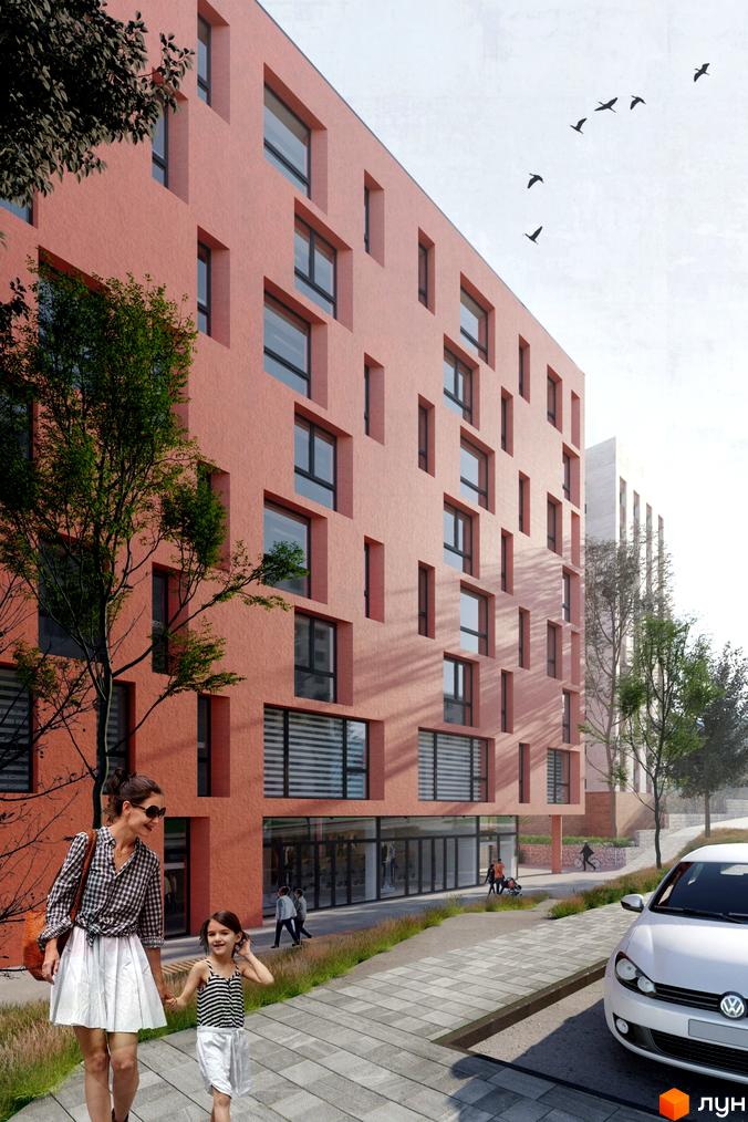 Апарт-комплекс Кампус з багатоповерховим будинком рожевого кольору та різними вікнами. На прибудинковій території видно дерева, пішохідну доріжку та припаркований автомобіль.