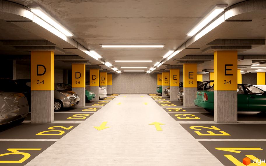 Підземний паркінг Житлового комплексу Метрополія-2 з бетонними колонами, яскравим освітленням та розміткою.