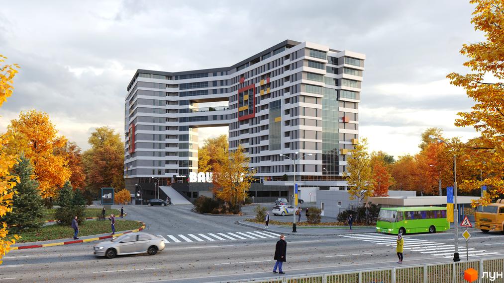 Новобудова Bauhaus з унікальною архітектурою та яскравими акцентами, оточена осінніми деревами та міською інфраструктурою.
