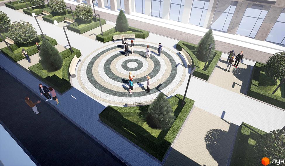 Житловий комплекс Ярославів Град: зона відпочинку з круговою бруківкою, лавками та зеленими насадженнями. Навколо комплексу розташовані доглянуті кущі та дерева, що створюють затишну атмосферу.