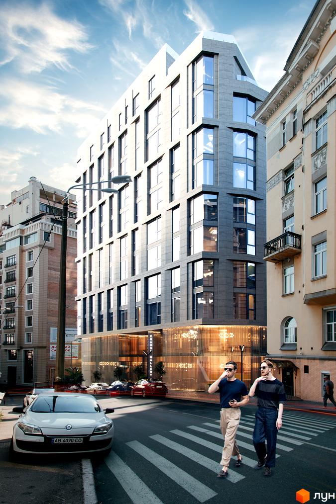 Житловий комплекс Krauss Gallery: багатоповерховий будинок з сірим фасадом, великими вікнами та скляним першим поверхом. На вулиці автомобілі та пішоходи.