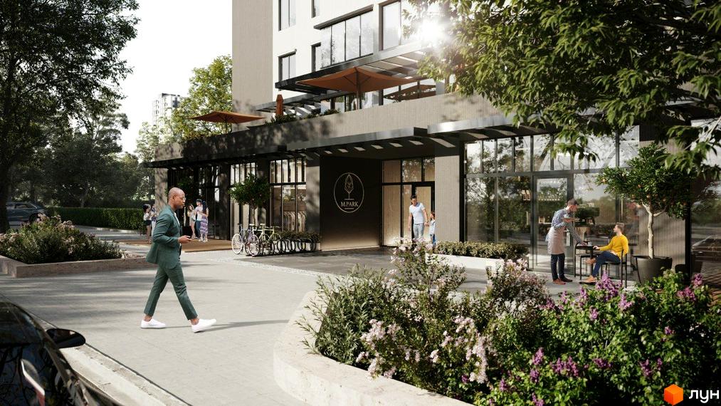 Житловий комплекс M.Park з великими вікнами та темним оздобленням, оточений доглянутою зеленню та пішохідними зонами.