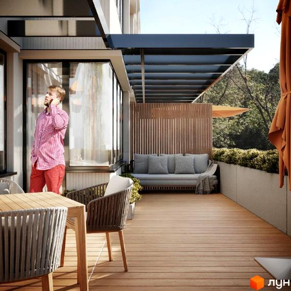 Тераса в ЖК M.Park з дерев'яною підлогою, диваном та столиком. Чоловік розмовляє по телефону біля панорамного вікна.