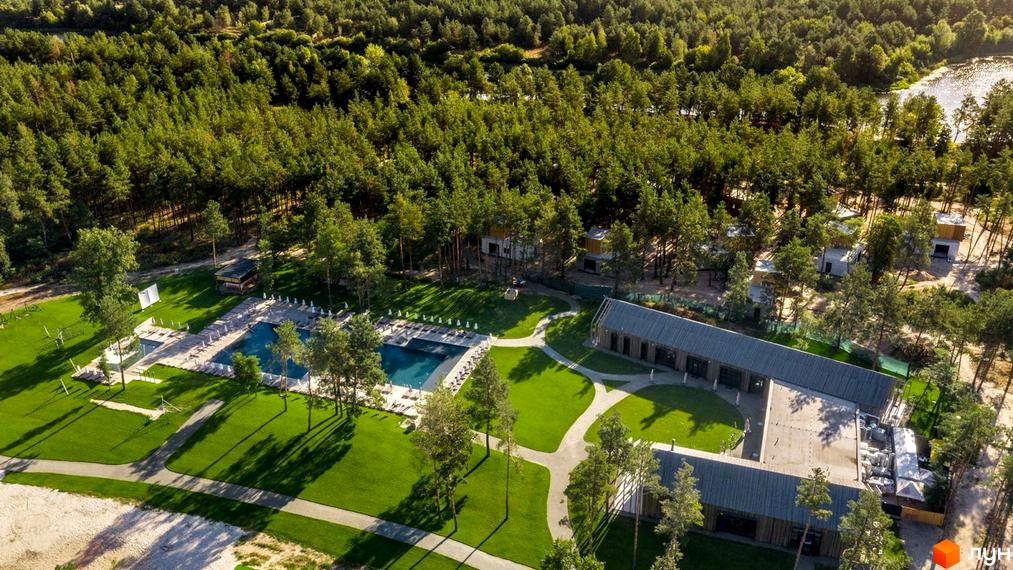 Котеджне містечко SHELEST.home з басейном та зеленою територією, оточене лісом. Сучасні будинки розташовані серед дерев.