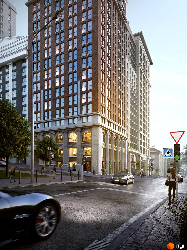 Висотна будівля ЖК Stanford з фасадом з цегли та світлого каменю. Навколо будівлі розташована дорога, тротуар та зелені насадження.