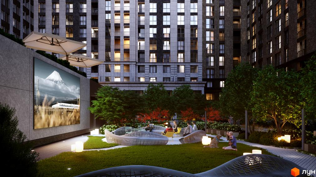 Житловий комплекс Stanford. Висотна будівля з великою кількістю вікон. На прибудинковій території зелені насадження, місця для відпочинку та великий екран.