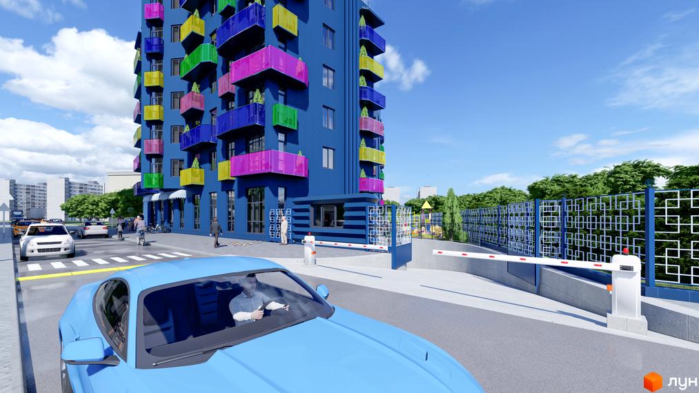 Житловий комплекс Калейдоскоп з яскравими балконами та огородженою територією з дитячим майданчиком. На передньому плані синій автомобіль.