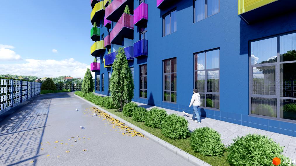 Житловий комплекс Калейдоскоп: яскравий синій будинок з кольоровими балконами та доглянутою прибудинковою територією з кущами та деревами.