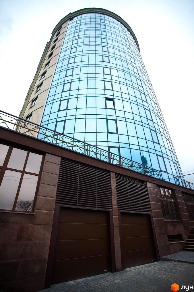 Зображення фасаду та скляної частини Житлового комплексу Paradise. Вигляд багатоповерхового будинку ззовні.