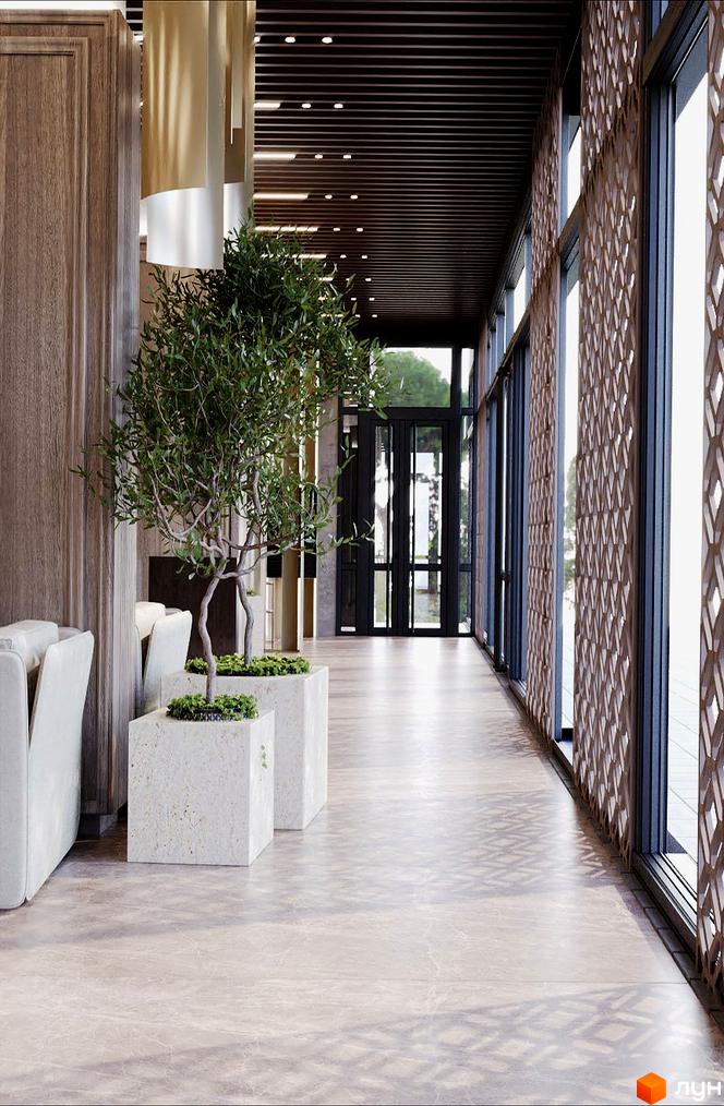 Інтер'єр холу Житлового комплексу Dynastia BC з великими вікнами та декоративними рослинами у бетонних вазонах.