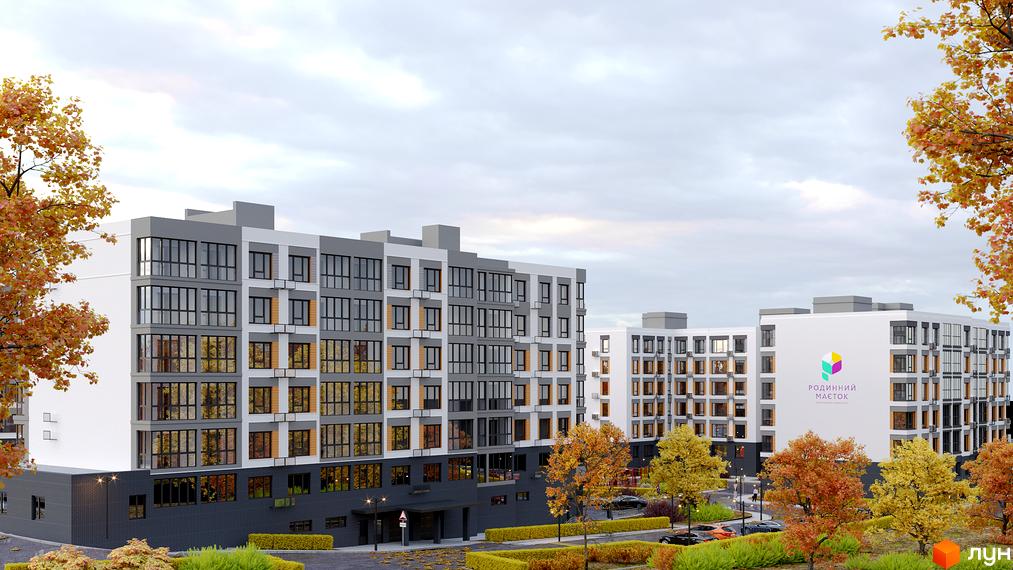 Зовнішній вигляд житлового комплексу Родинний маєток з фасадами сірого та білого кольорів, великими вікнами та прибудинковою територією з деревами восени.