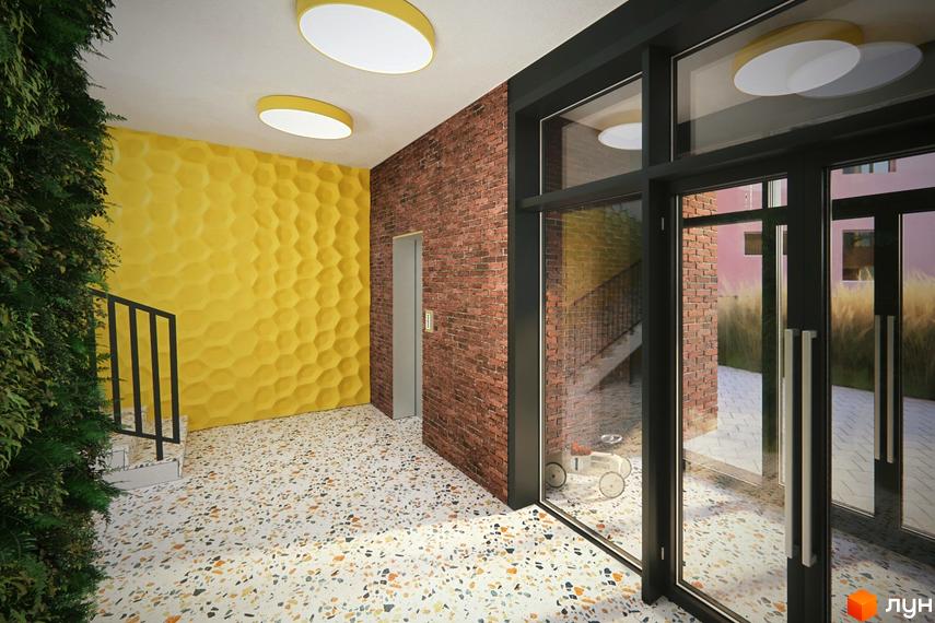 Інтер'єр холу житлового комплексу Там Де Дім з цегляною стіною, жовтою стіною з рельєфом та дверима до сходів.