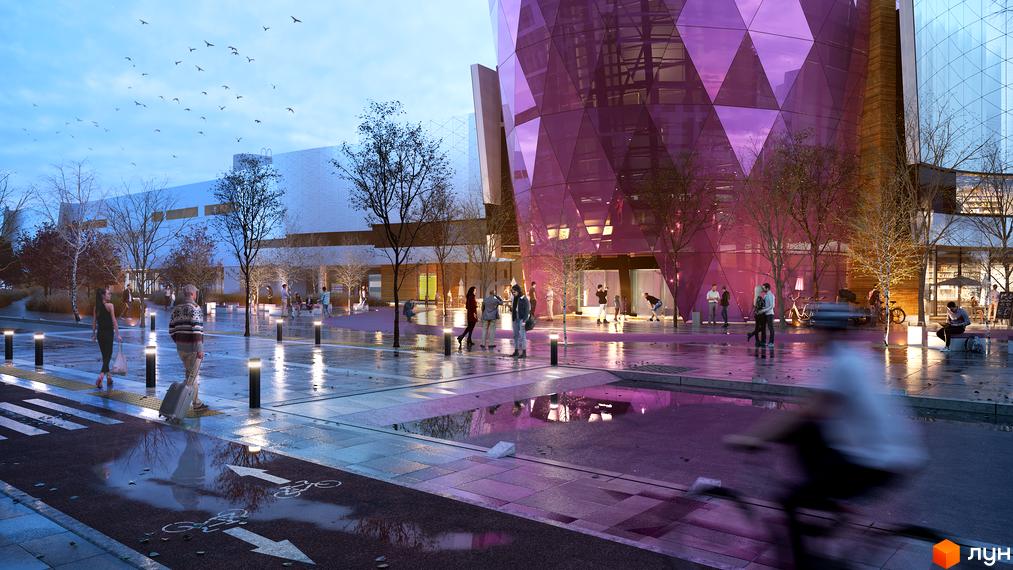 Житловий комплекс Respublika з фасадом з рожевого скла та прилеглою площею з деревами, пішоходами і велодоріжкою.