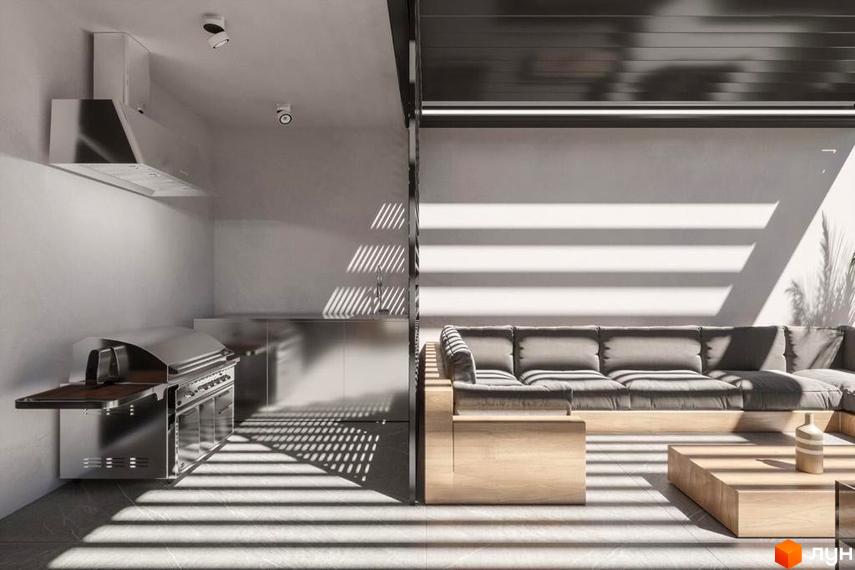 Інтер'єр кухні-вітальні в ЖК Dynastia BC. Кухня з грилем та витяжкою, зона відпочинку з диваном та кавовим столиком. Сонячне світло підкреслює простір.