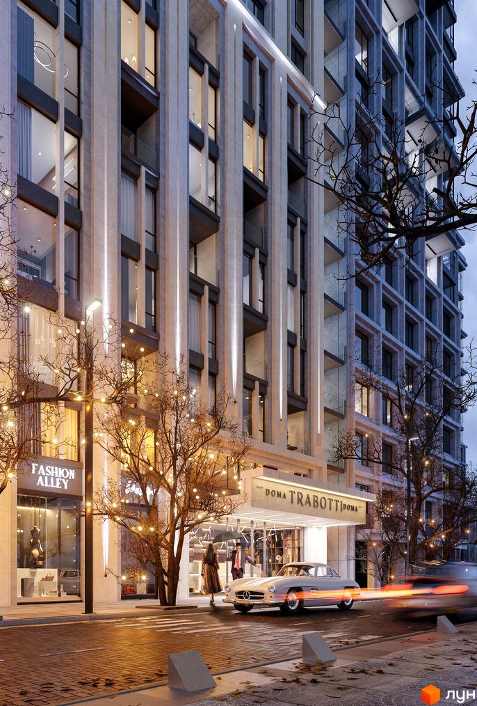 Фасад житлового комплексу Doma Trabotti з підсвіченими вікнами та декором, поруч дерева з гірляндами та старовинний автомобіль.