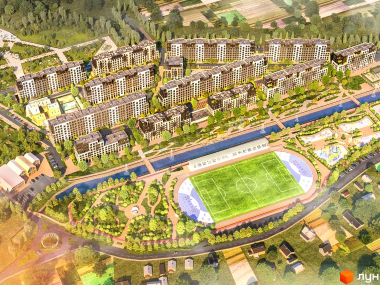 Вид згори на житловий комплекс Riverside з сучасними багатоповерховими будинками, спортивним стадіоном та парковою зоною біля річки.