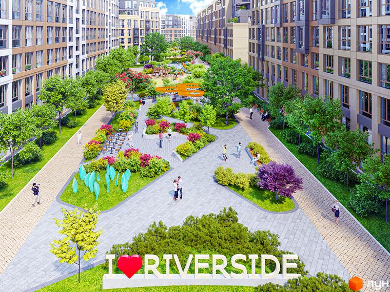 Житловий комплекс Riverside: фасади будинків з великою кількістю вікон та зелена прибудинкова територія з зонами відпочинку та дитячими майданчиками.
