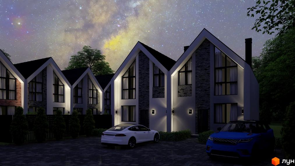 Зображення будинків у Котеджному містечку Villa Gatne вночі. На передньому плані автомобілі та освітлена прибудинкова територія.