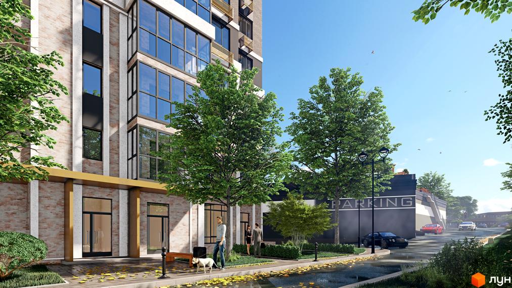 Житловий комплекс Голосіївський з цегляним фасадом та великими вікнами, зеленою прибудинковою територією та парковкою.