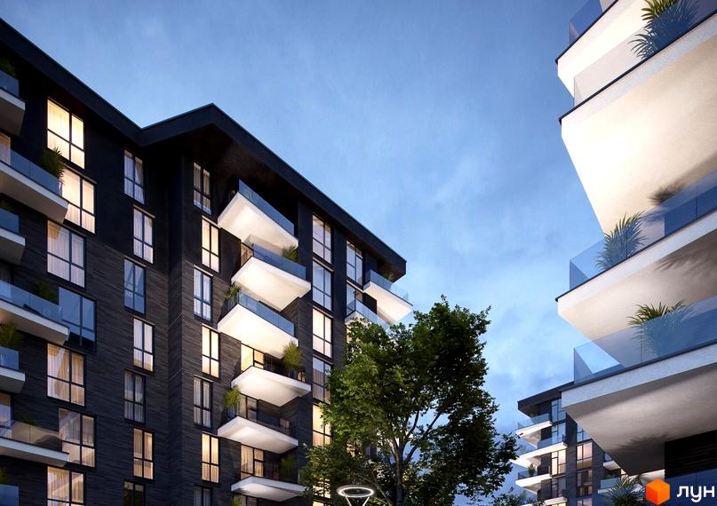 Житловий комплекс Artynov Hall ввечері, з темним фасадом, білими балконами та скляними поручнями. Поруч видно дерева та освітлення.