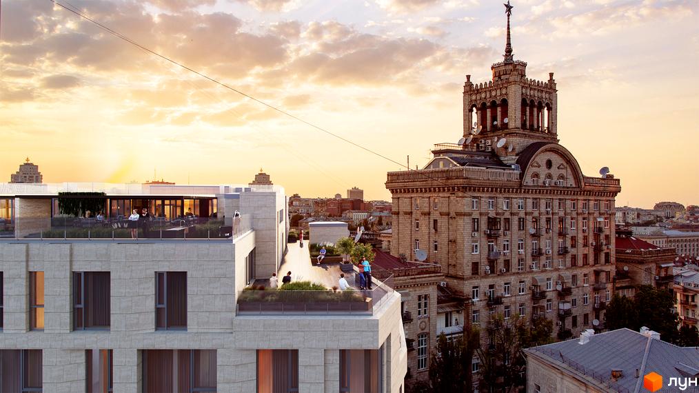 Житловий комплекс Krauss Gallery з фасадом світлого кольору та великими вікнами. На даху облаштовані зони відпочинку з озелененням.