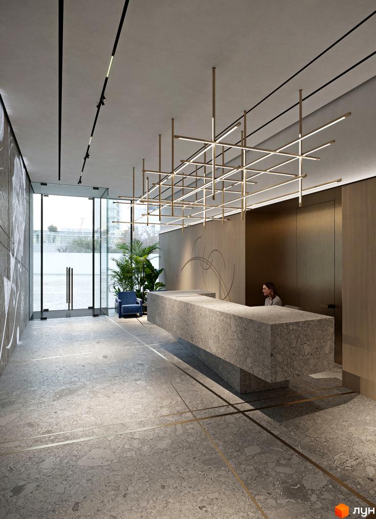 Інтер'єр холу в житловому комплексі Kandinsky Odesa Residence з мармуровою стійкою ресепшен, скляними дверима та декоративним освітленням.