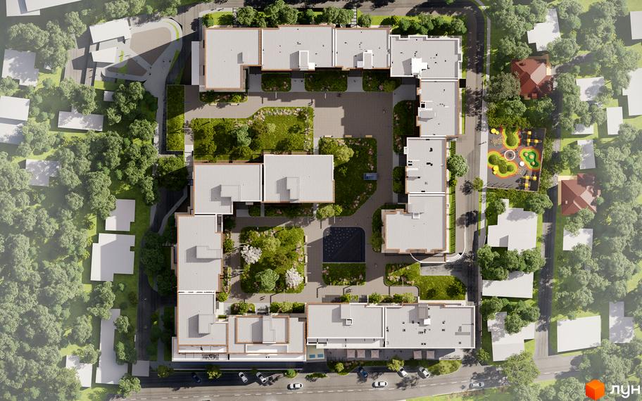 Вид зверху на житловий комплекс Compass з сірими дахами та внутрішнім двором з зеленими насадженнями та дитячим майданчиком.