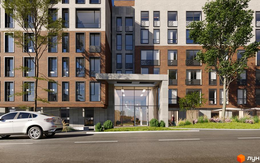 Зовнішній вигляд житлового комплексу Compass з цегляним фасадом та скляним входом. Навколо комплексу зелені насадження та припаркований автомобіль.