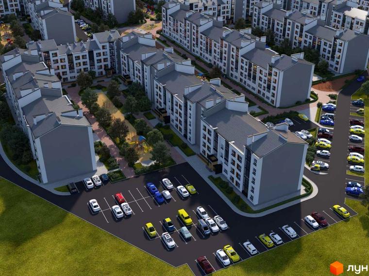 Житловий комплекс Grand Comfort з парковкою та доглянутою прибудинковою територією. Багатоквартирні будинки з сірими дахами та фасадами, озеленення території.