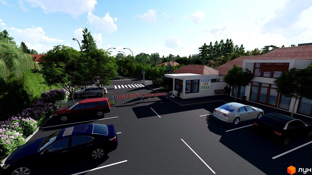 Котеджне містечко GoodLife Park: світлі будівлі з коричневими віконними рамами та червоними дахами, поруч паркінг з автомобілями та зелені насадження.