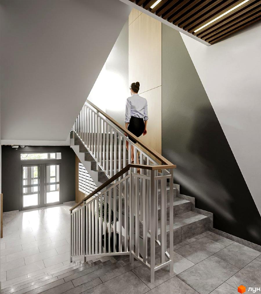 Інтер'єр сходової клітки в Житловому комплексі Джем Сіті. Сходи з металевими перилами та дерев'яними поручнями.