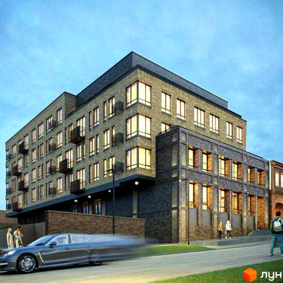 Зображення фасаду будівлі Клубний будинок на Короленка. Цегляний будинок з великими вікнами та балконами, розташований на вулиці з автомобілем.