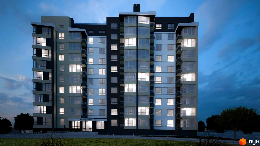 Зовнішній вигляд житлового комплексу Кардамон з підсвіченими вікнами та балконами на тлі вечірнього неба. Прибудинкова територія з деревами та освітленням.