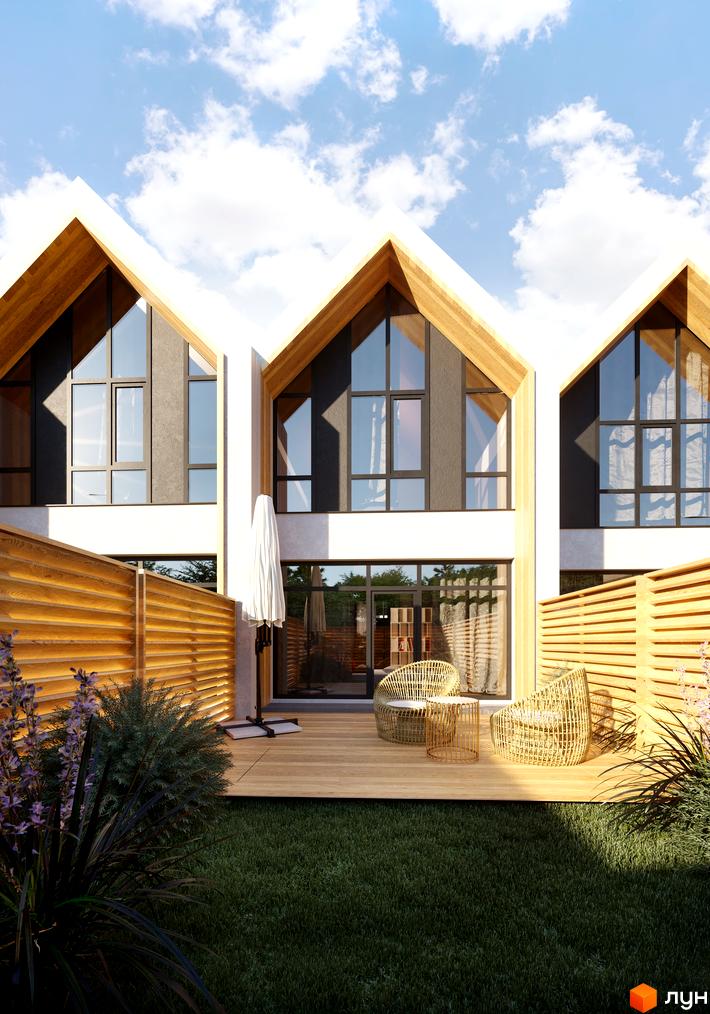 Котеджне містечко Comfort Life Villas з трикутними дахами та дерев'яними елементами. На прибудинковій території зелена галявина, дерев'яний настил та вуличні меблі.