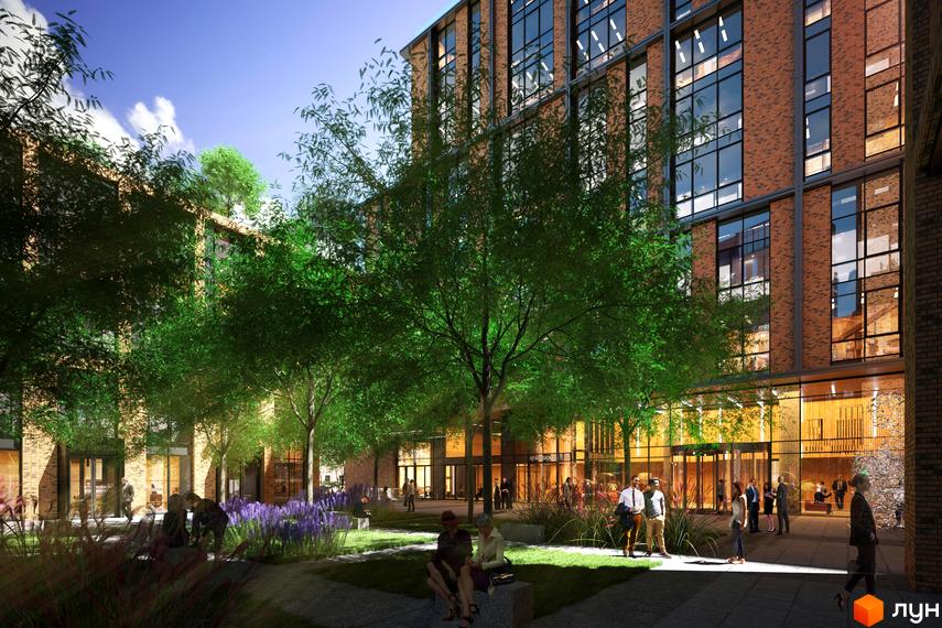 БФК Ermolaev Center з цегляним фасадом та великими вікнами, оточений деревами та лавандою. На території комплексу розташовані зони для відпочинку та прогулянок.