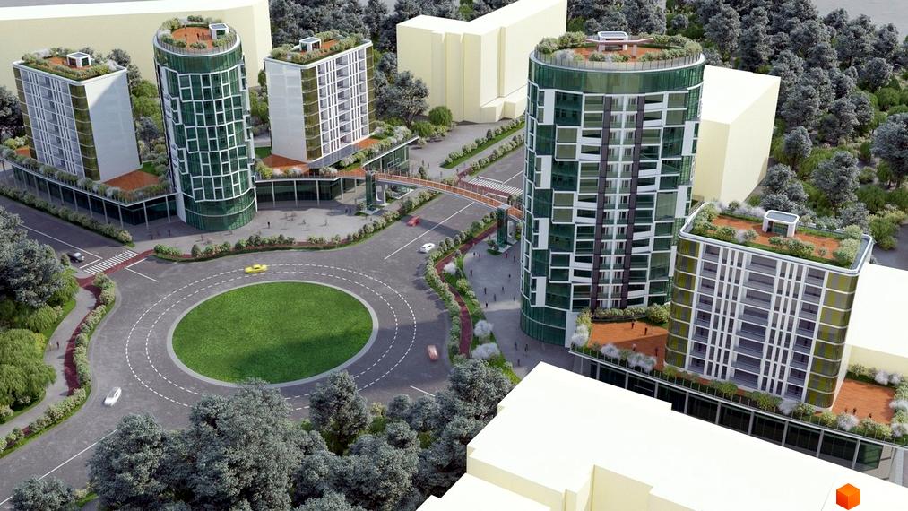 Житловий комплекс Смарагдові вежі з зеленими фасадами та круглою формою, з пішохідним мостом та круговою розв'язкою. Навколо зелені насадження та дерева.