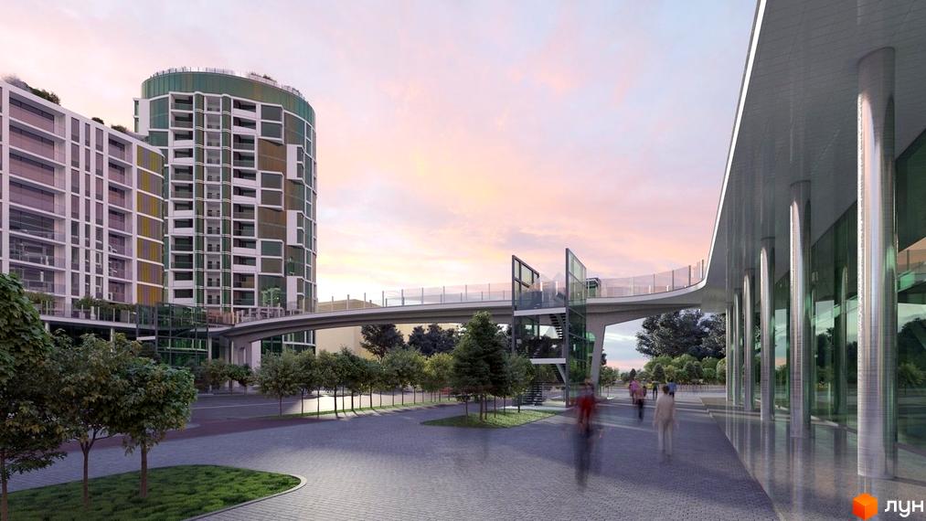 Житловий комплекс Смарагдові вежі з оригінальною фасадною обробкою та скляним переходом між будинками. Територія навколо новобудови облаштована пішохідними доріжками та зеленими насадженнями.