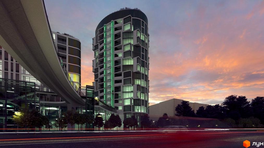Житловий комплекс Смарагдові вежі. Вигнута будівля з зеленою підсвіткою та багаторівневими вікнами. Навколо - міська забудова та дорога.