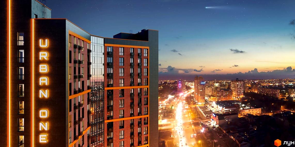 Зовнішній вигляд новобудови Urban One Klochkivska вночі з підсвіченими літерами на фасаді та міським пейзажем на фоні.